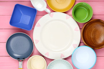 Different tableware on wooden background
