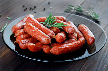 Smoked sausages on wooden table