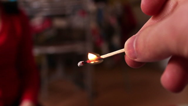 man lights a match fire
