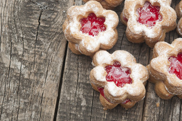 Jelly cookies flower with red jam homemade on vintage table top