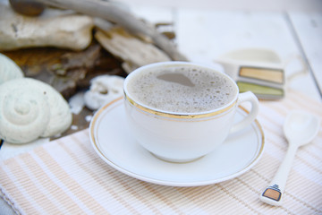 Morning coffee in white, off white, sea debris on the back