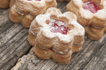 Jelly cookies flower with red jam homemade on vintage table top