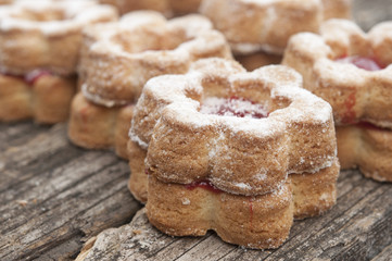 Jelly cookies flower with red jam homemade on vintage table top