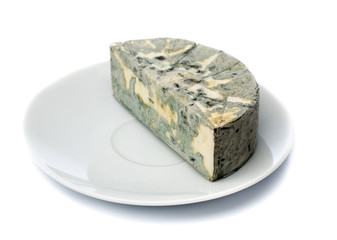 Cheese with black mold on a plate for food lovers.