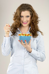 Female model hold green salad in blue bowl ready to eat.