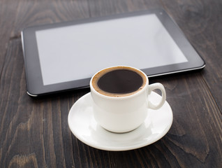 Obraz na płótnie Canvas Cup of coffee and tablet