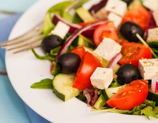 Greek salad on wooden background