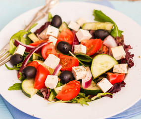 Greek salad on wooden background