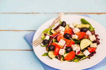 Greek salad on wooden background