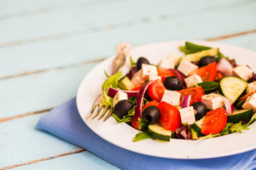 Greek salad on wooden background