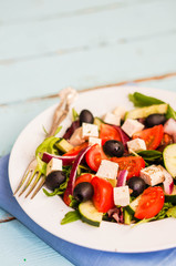 Greek salad on wooden background