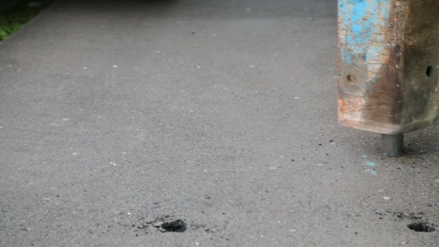 Asphalt demolishing with jackhammer tool at construction site