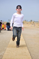 Boy running on the beach of Caesarea