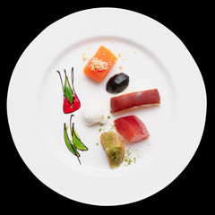Desserts on plate, isolated on black