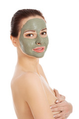 Beautiful woman with clay facial mask