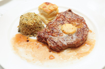 Rib eye steak with bulgur, butter and potato gratin