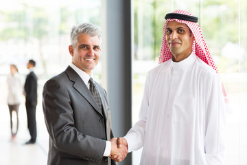 senior businessman handshake with Arabian partner