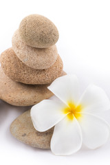 Fototapeta na wymiar isolated of the balance stones with Frangipani flower is zen for
