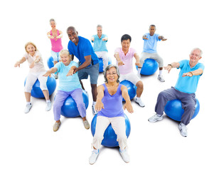 Group Of Multi-Ethnic Senior Adults Exercising With Instructor