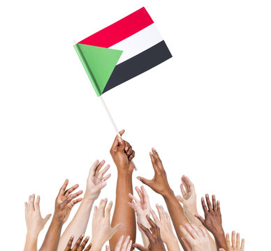 Group Of Multi-Ethnic People Holding The Flag Of Sudan