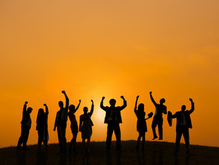 Silhouette of Business People Celebrating At Sunset