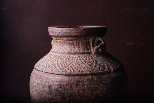 Earthenware jug standing on dark room
