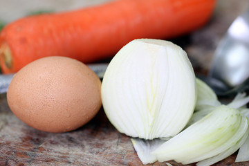 Fresh of onion and egg on chopping board.