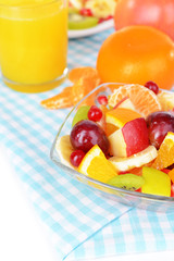 Sweet fresh fruits in bowl on table close-up