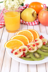 Sweet fresh fruits on plate on table close-up