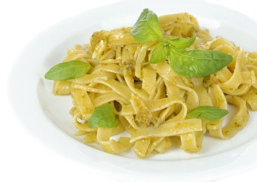 Delicious pasta with pesto on plate close-up