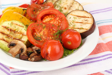 Delicious grilled vegetables on plate on table close-up