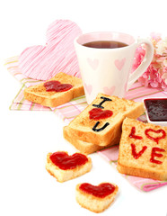 Delicious toast with jam and cup of tea on table close-up