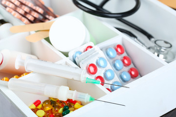 Medical pills, ampules in wooden box, on color wooden