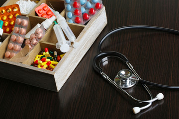 Medical pills,stethoscope,  ampules in wooden box,