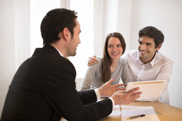 Young Couple meeting real-estate agent to buy property