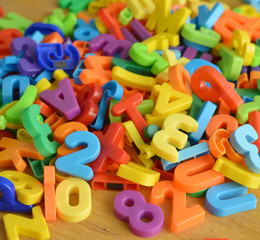Many colorful letters and numbers on a table