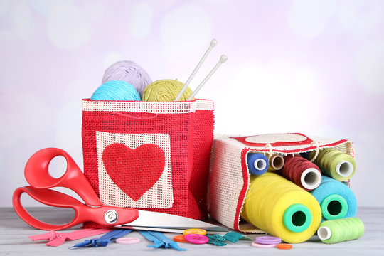 Bags with bobbins of colorful thread and woolen balls