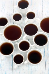 Many cups of tea on table close-up