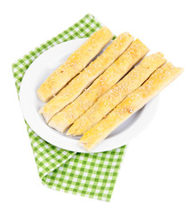 Tasty bread sticks on plate isolated on white