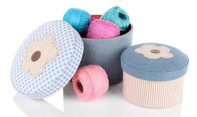 Decorative boxes with colorful skeins of thread isolated