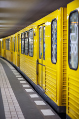 Naklejka premium Yellow metro in subway station. Berlin, Germany.