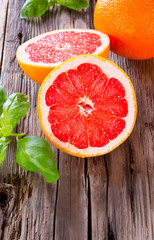 Fresh grapefruit with slices on a wooden table. Wooden backgroun