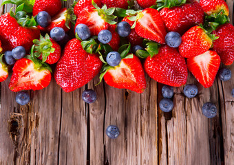 Fresh berries on wooden background, strawberry and blueberry fru