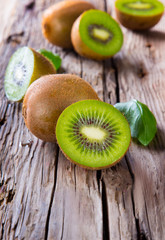 Fresh kiwi fruits on wooden table. Wooden background. 