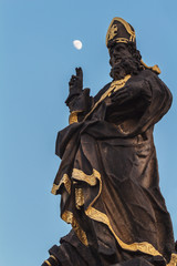 Statue of saint and moon in the sky