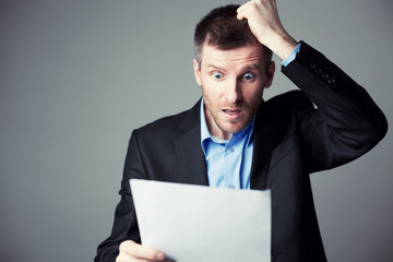 terrified businessman reads contract