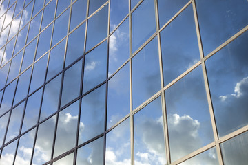 reflexions of clouds and  sky in facade of modern building