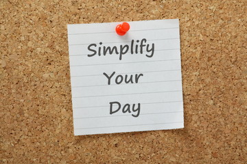 Simplify Your Day message on a cork notice board