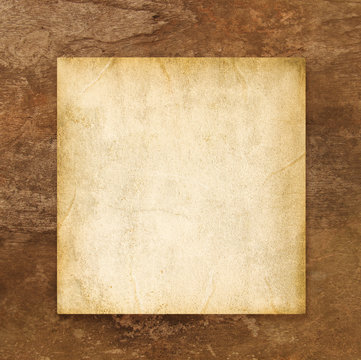Old blank paper on brown weathered wooden background