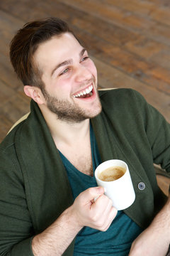 Man smiling with cup of coffee